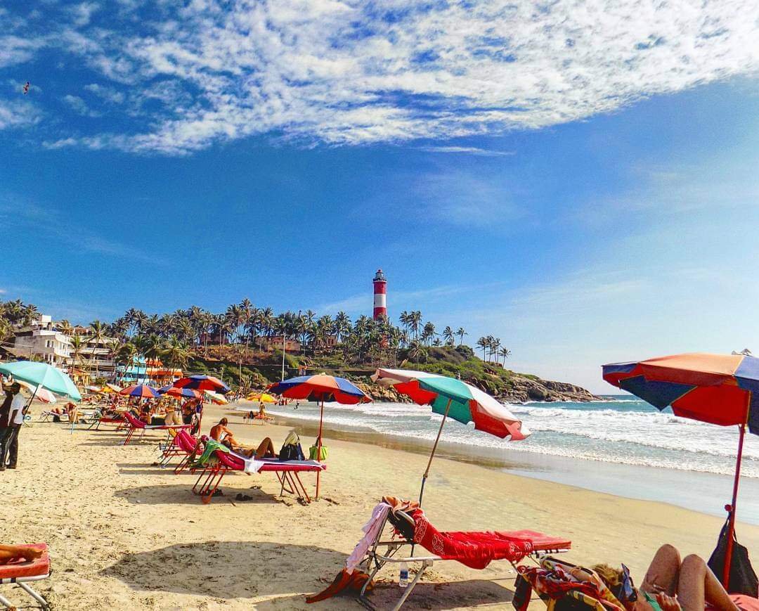 Kovalam Beach with lighthouse and beach umbrellas
